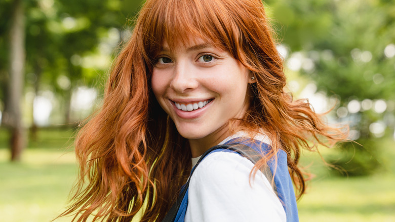 A woman smiling at the park