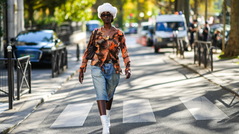 Woman wearing printed blouse, jorts