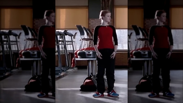 Julia Stiles in "Save the Last Dance" wearing black cargo pants and a red-and-black raglan T-shirt.