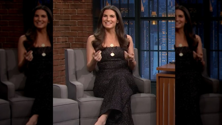 Kaitlan Collins smiles wearing a glitter black jumpsuit