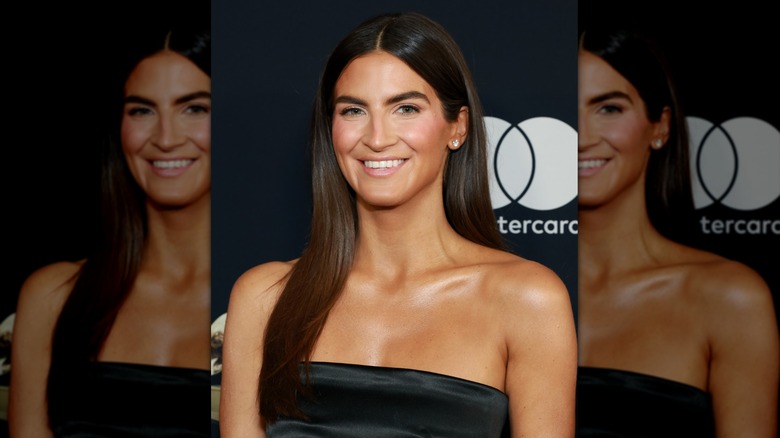 Kaitlan Collins with long straight hair and a middle part