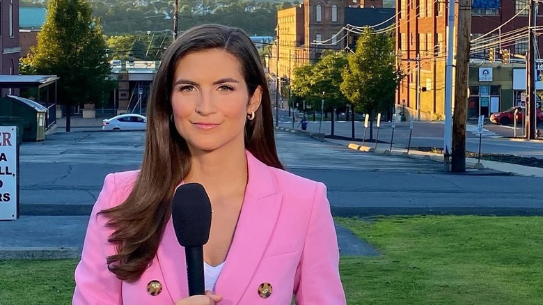 Kaitlan Collins with long straight hair and a side part
