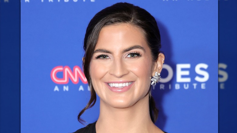 Kaitlan Collins with an updo and a side part