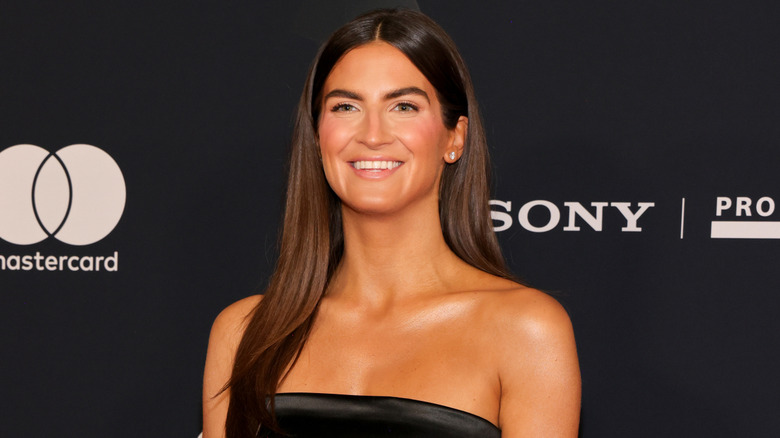 Kaitlan Collins with long straight hair and a middle part