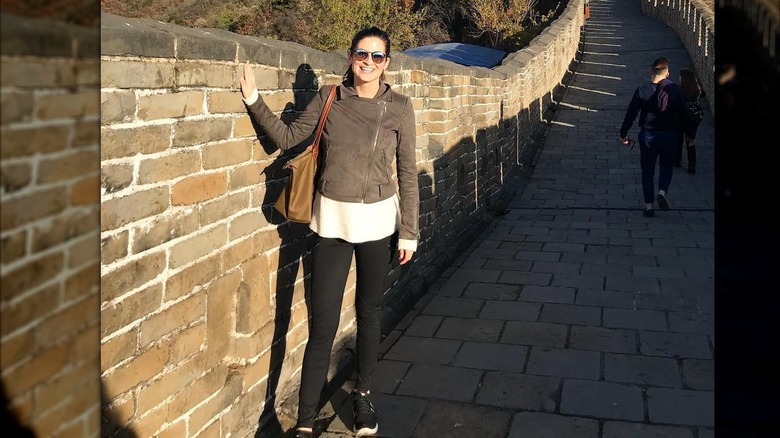 Kaitlan Collins smiles as she poses visiting the Great Wall of China (2017)
