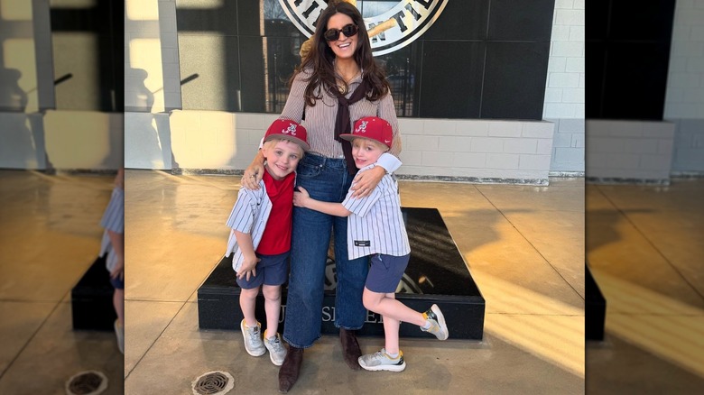 Kaitlan Collins poses for a photo with her nephews at a University of Alabama game