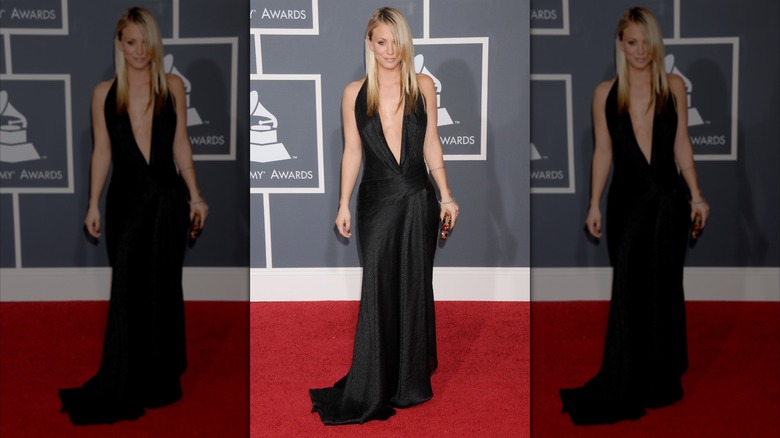 Kaley Cuoco poses on the red carpet in a black dress