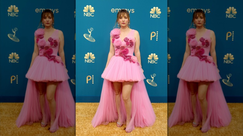 Kaley Cuoco poses on the red carpet in a pink dress