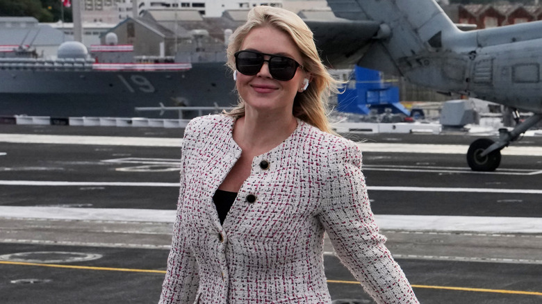 Karoline Leavitt arrives in Japan with earbuds in