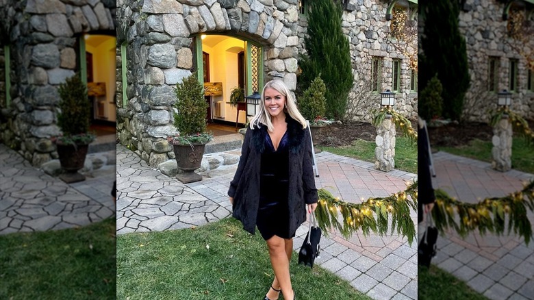 Karoline Leavitt posing in a navy dress and fur coat