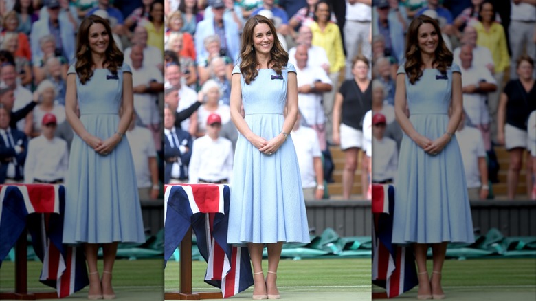 Kate Middleton posing in a light-blue dress with cap sleeves at the Wimbledon Tennis Championships in July 2019.