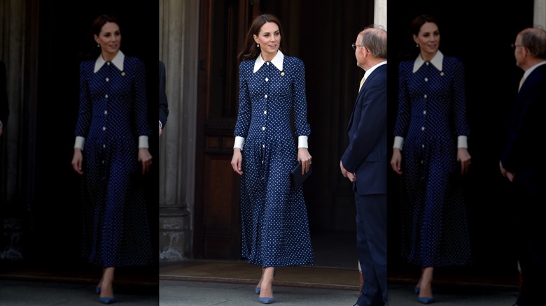 Kate Middleton wearing a dark-blue polka-dot dress with a white collar during a visit to Bletchley Park in 2019.