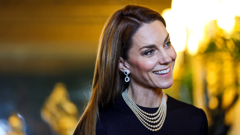 Kate Middleton smiling at Windsor Castle with straight hair