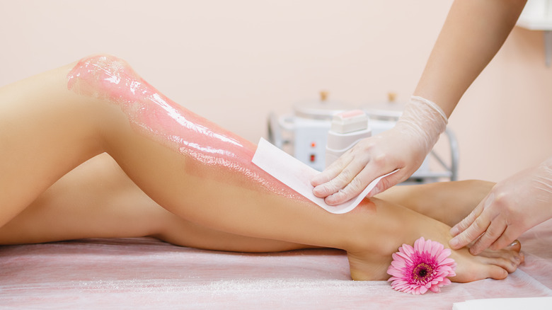 Woman getting legs waxed