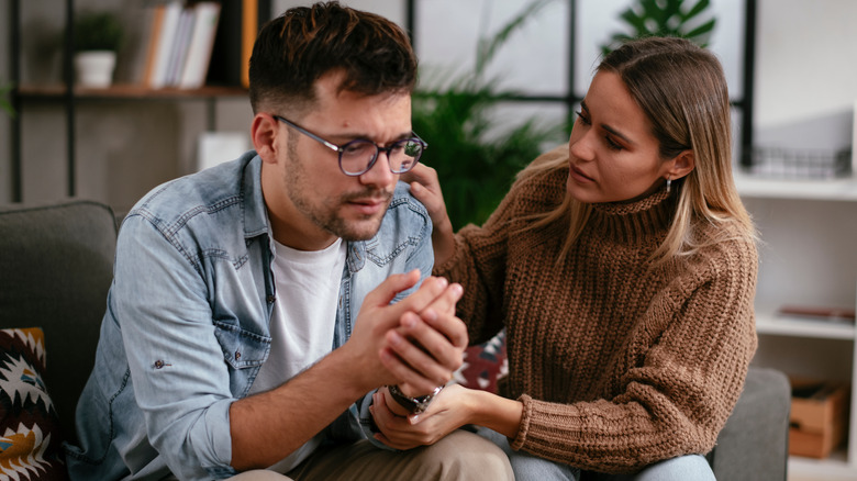 woman comforting sad man