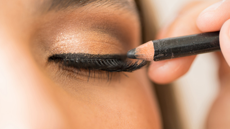 Woman applying Kohl eyeliner