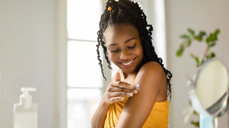 Woman applying body butter