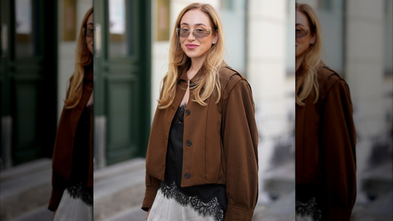 Sonia Lyson in a brown jacket and black camisole during Copenhagen Fashion Week in August 2025.