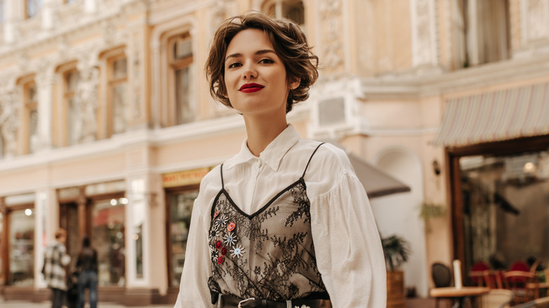 Woman wearing lace top over white shirt