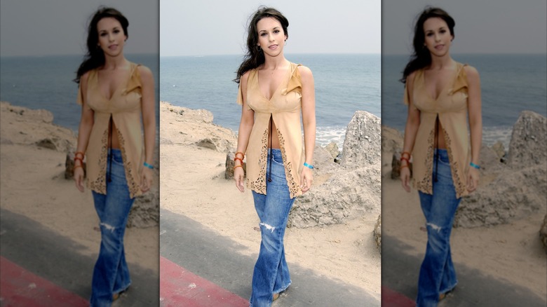 Lacey Chabert poses on a beach overlooking the water