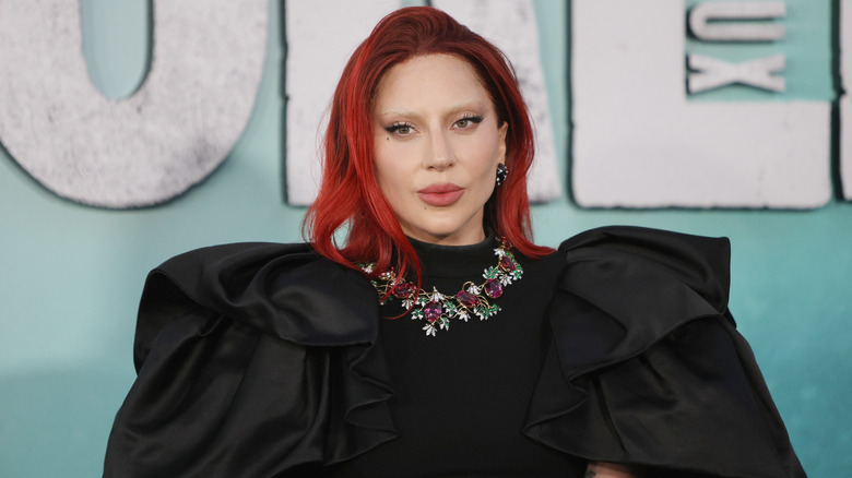 Lady Gaga in a red wig on the red carpet