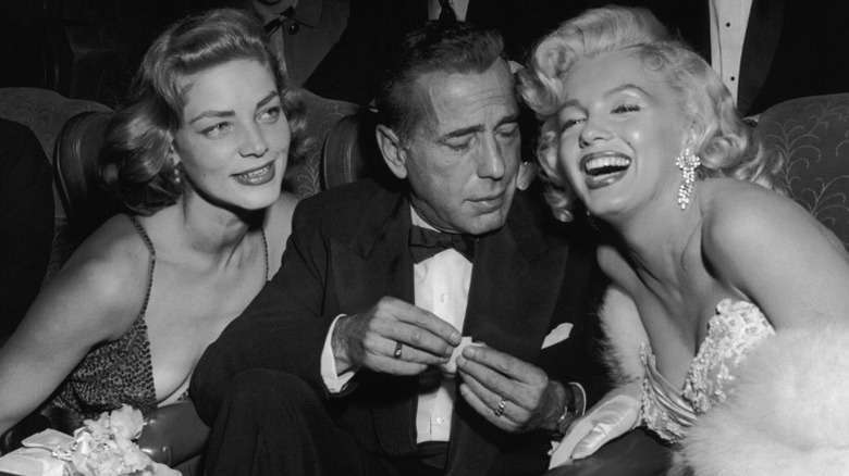 Lauren Bacall, Humphrey Bogart, and Marilyn Monroe at a film premiere