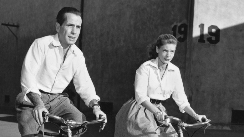 Humphrey Bogart and Lauren Bacall ride bikes on the set of Key Largo