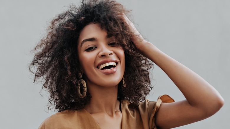 woman touching her hair 