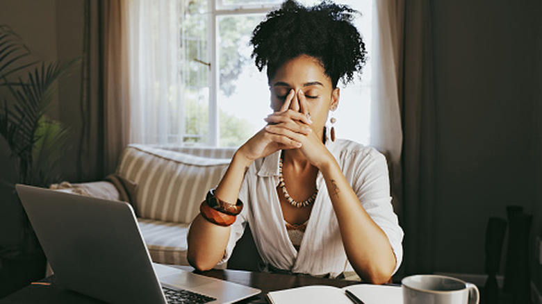 stressed out woman sitting at desk
