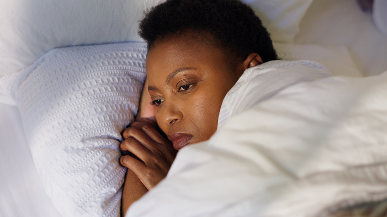 woman in bed unable to sleep