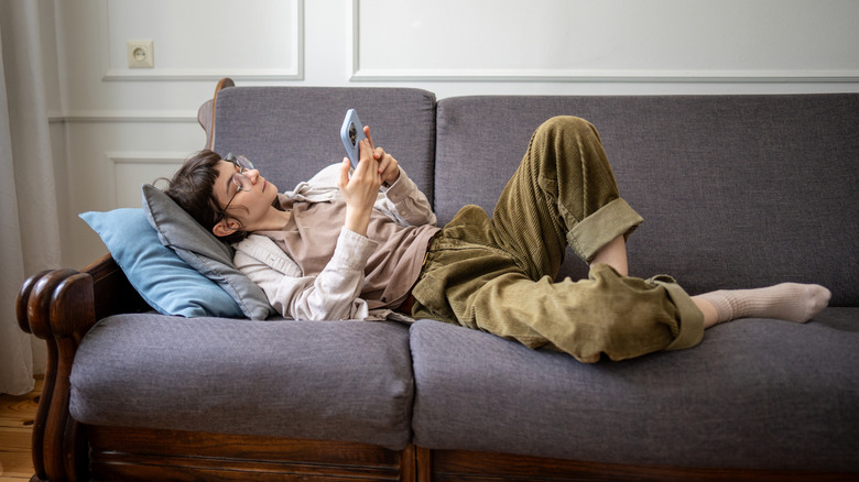 lazy woman on the couch doomscrolling