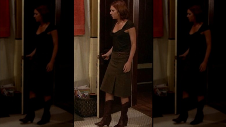 Lily Aldrin wearing a long brown skirt and cowboy boots