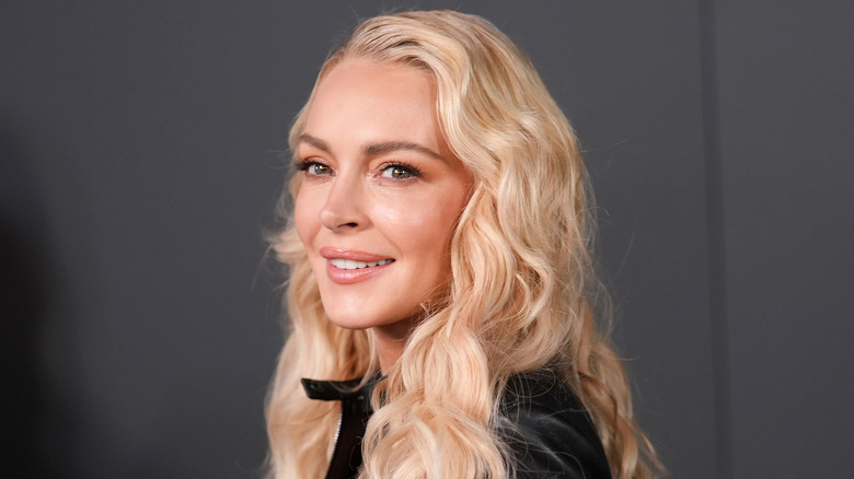 Lindsay Lohan smiles in black leather jacket