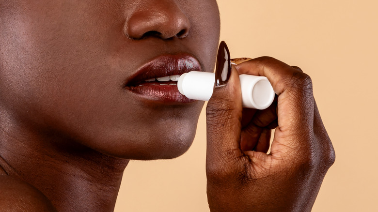 woman applying lip balm