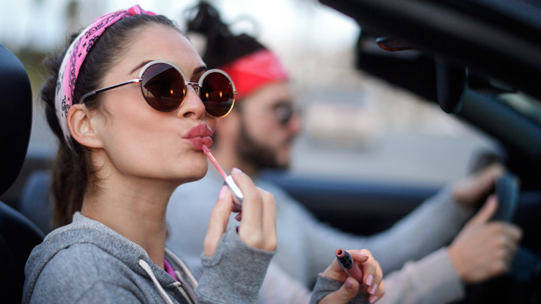 Woman applying lipstick