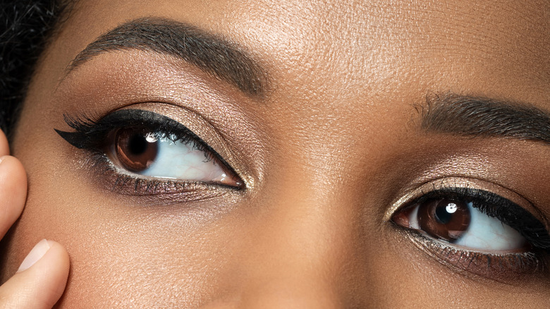 Create winged eyeliner with liquid liners