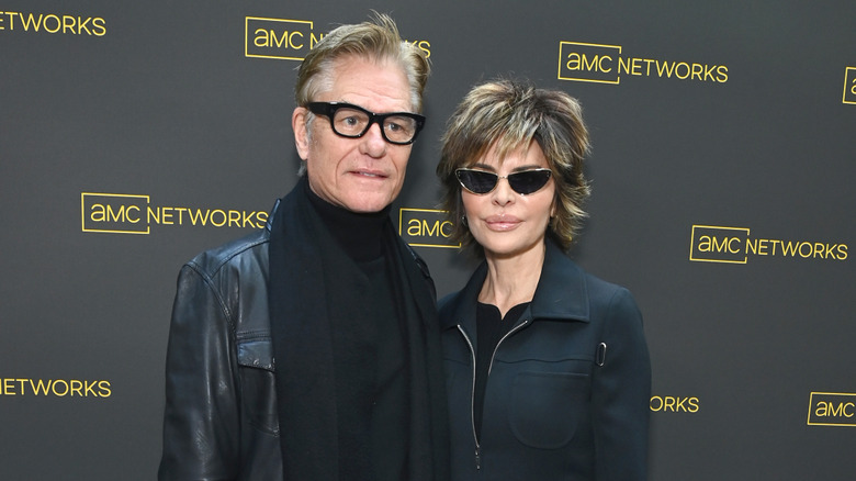 Lisa Rinna and Harry Hamlin posing in black outfits