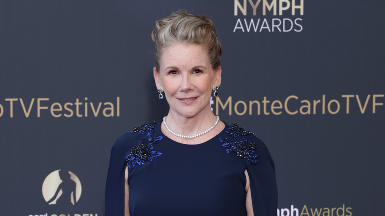 Melissa Gilbert smiles wearing an embellished blue dress