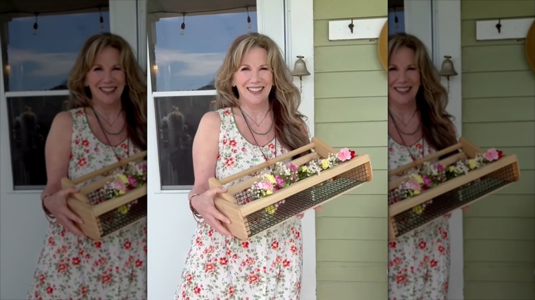 Melissa Gilbert smiles wearing a floral dress