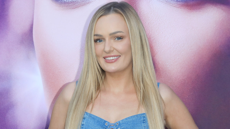 Love is Blind contestant Micah Lussier smiles for photos while attending a movie premiere