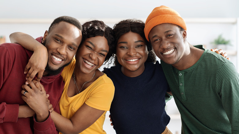 four friends smiling at camera 