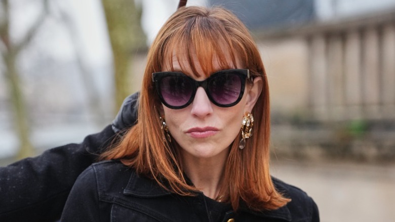 A woman with bangs and a blunt haircut