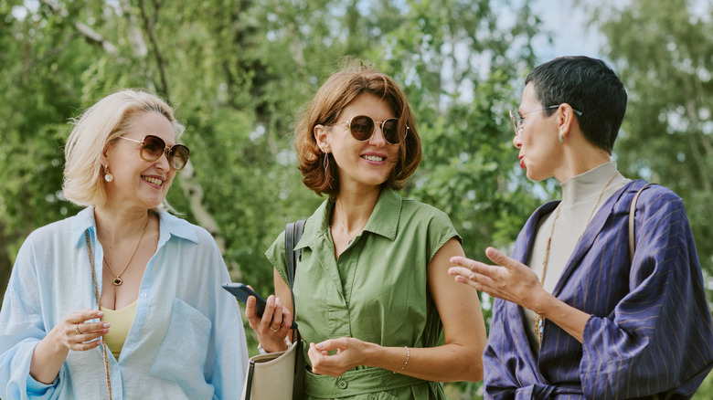 Three women walk and talk