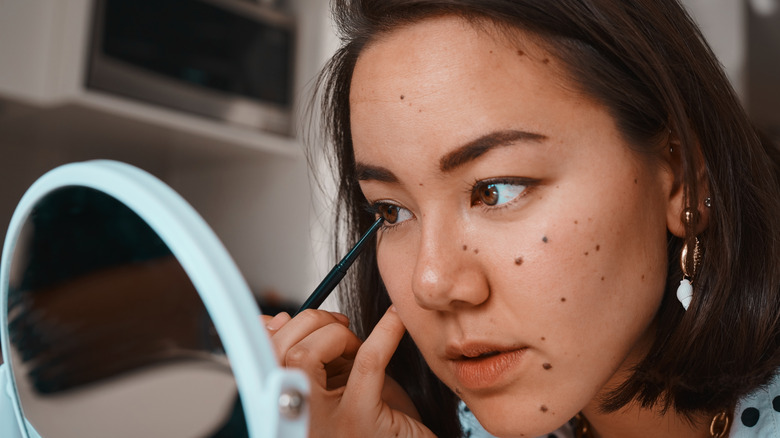 Person applying product to lower eyelashes