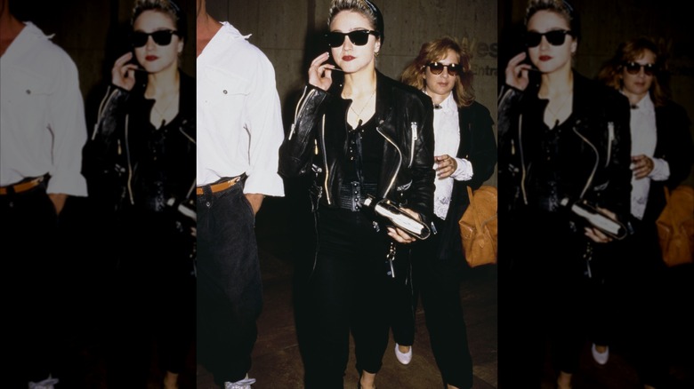 Madonna wears an all-black outfit and leather jacket