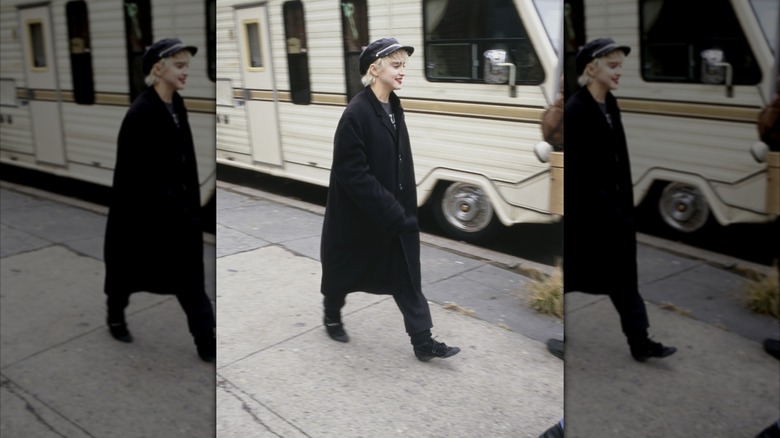 Madonna on set of "Who's That Girl" wearing a black coat and newsboy cap
