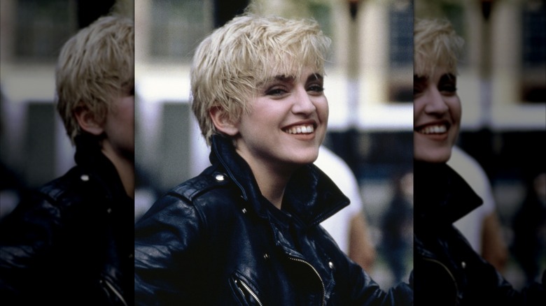 Madonna smiles in a black leather jacket