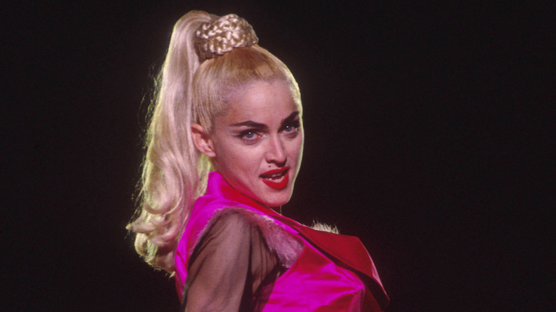 Madonna performs in a pink outfit and high ponytail