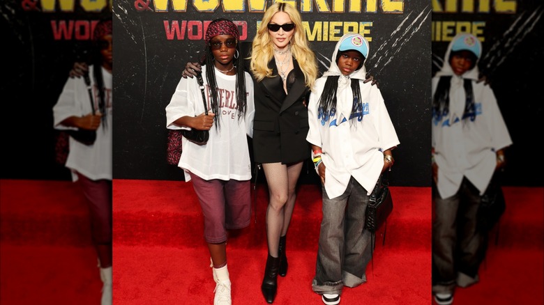 Madonna in 2024 posing with her twin daughters