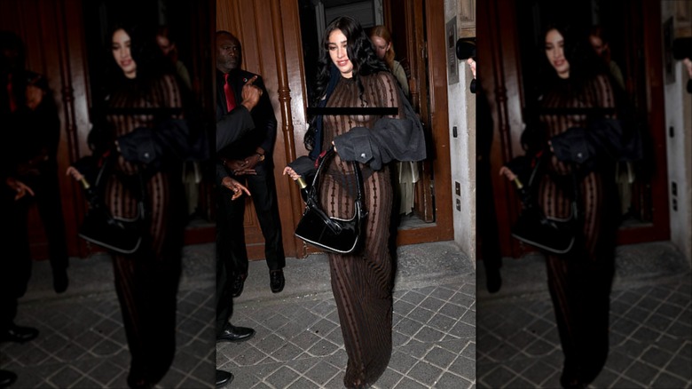 Lourdes Leon wearing a sheer brown dress topped with a gray cropped trench coat.